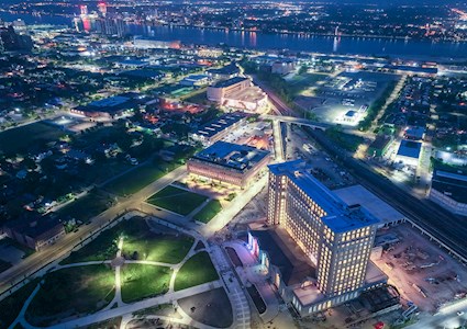 The towering former train station is shown at night, all lit up. 