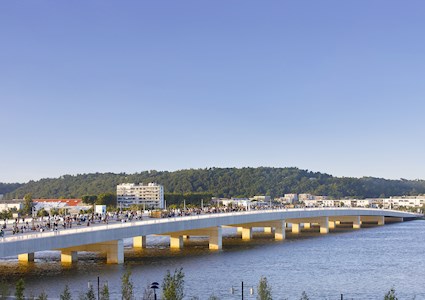 A wide concrete bridge is crowded with people rather than vehicles. 