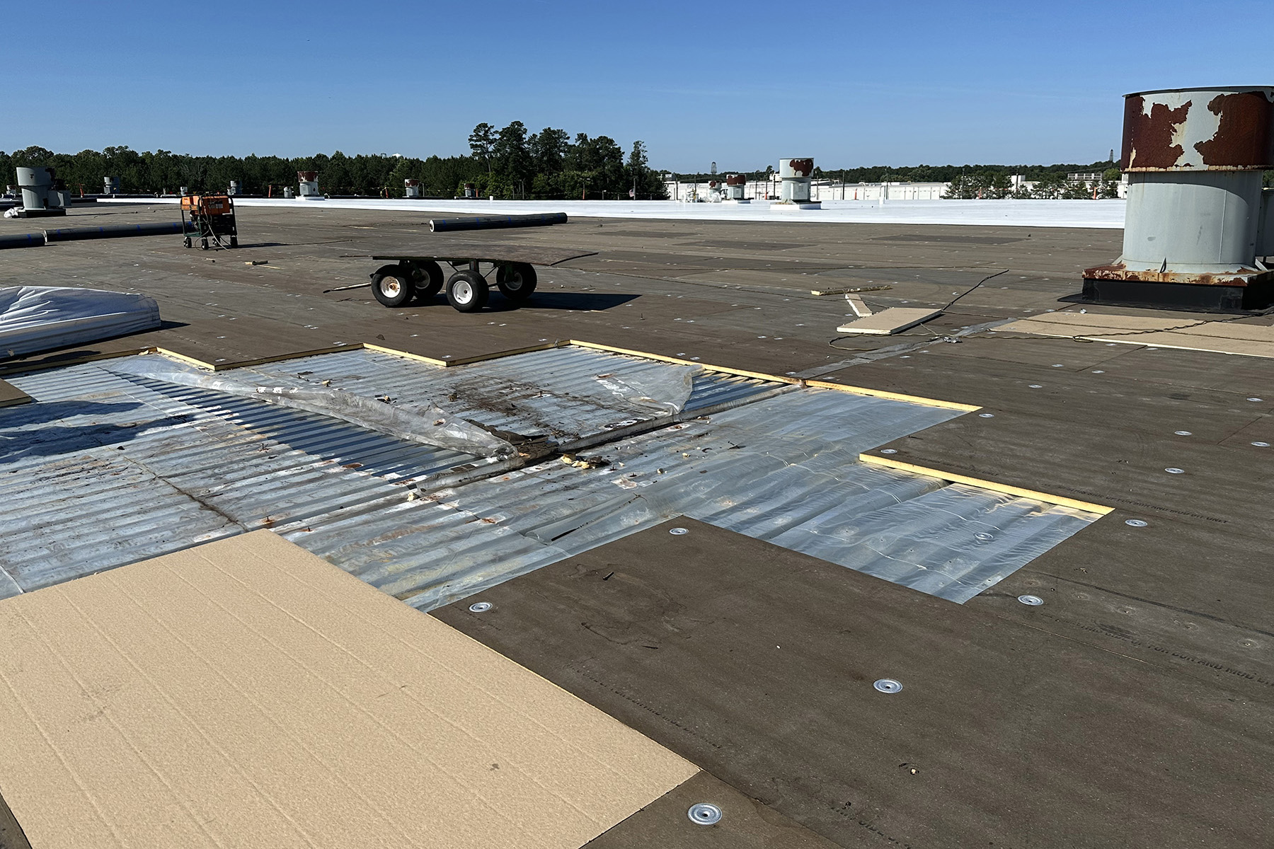 The photograph shows a roof under repair. 