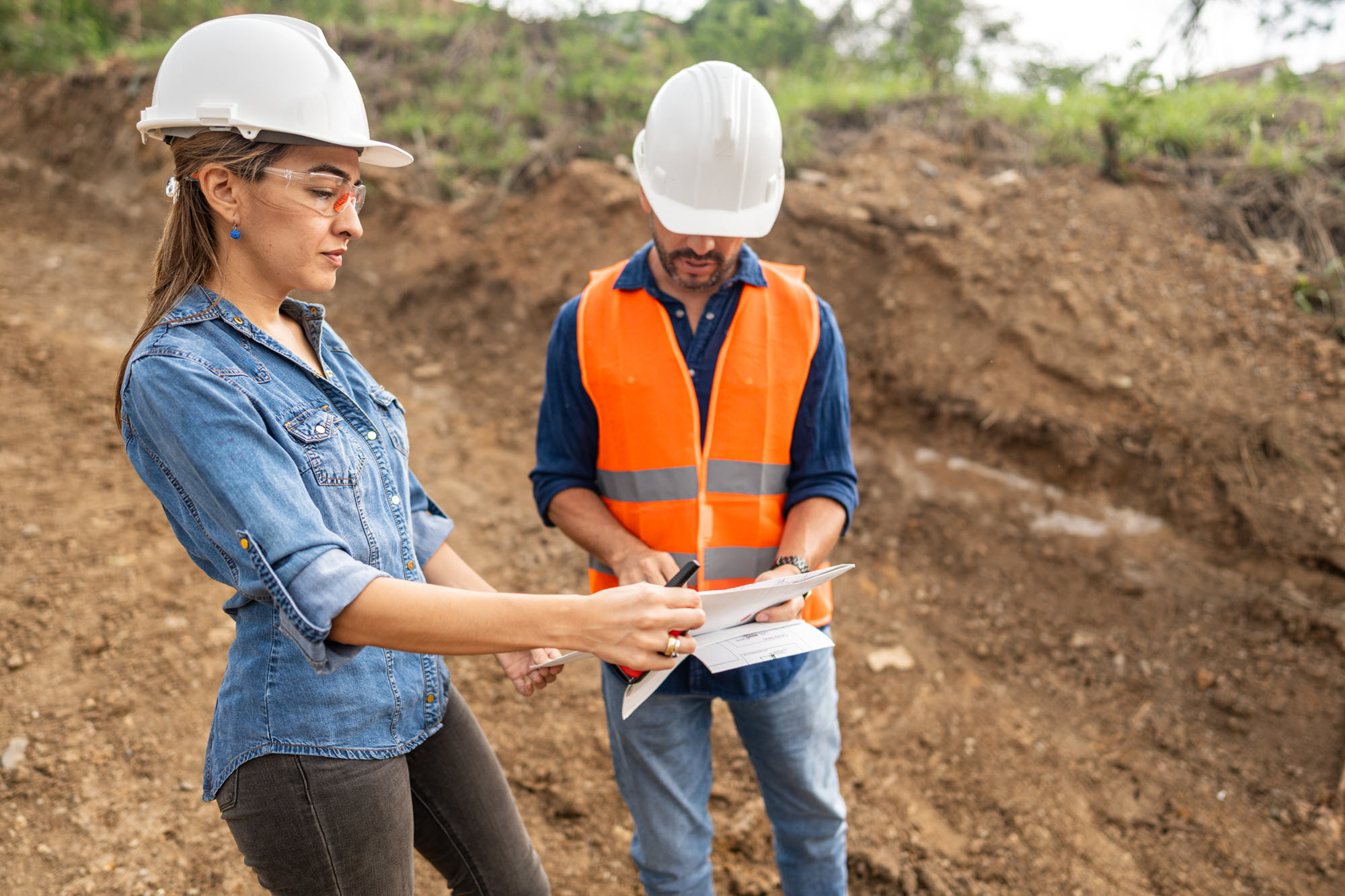 photo of two engineers looking at plans