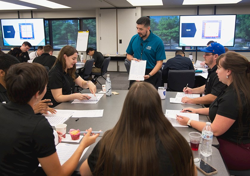 instructor showing young civil engineers instructions during a workshop